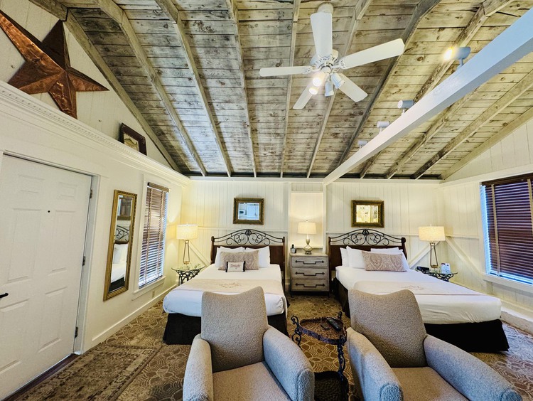 Room with two twin beds and chairs