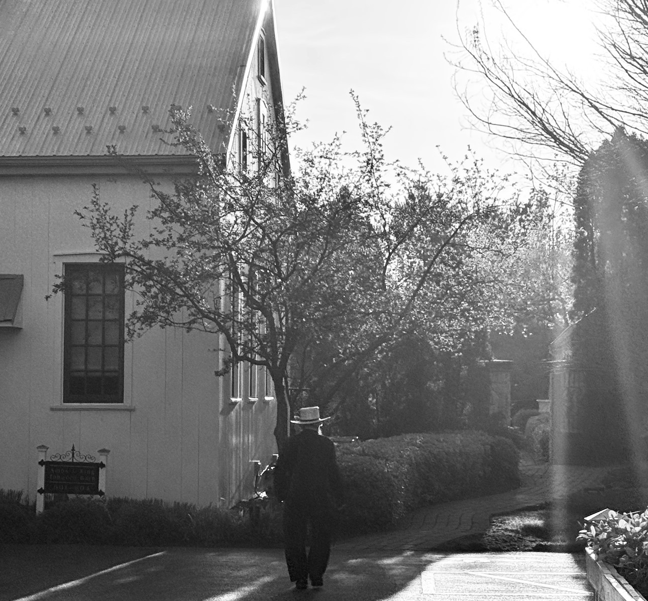 Historic photo of man standing next to Inn